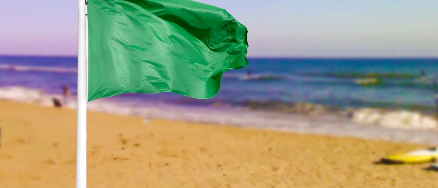 Green flag on beach