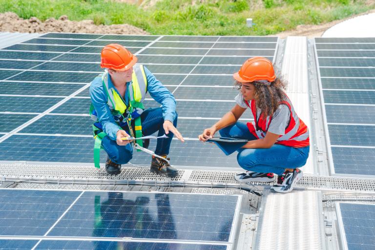 Person being trained to install solar panels.