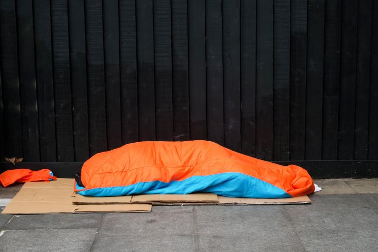 A homeless person sleeping on the street