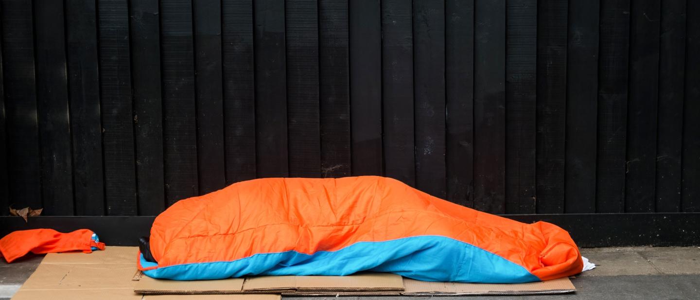 A homeless person sleeping on the street